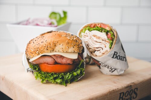 Sandwich and wrap on wooden board