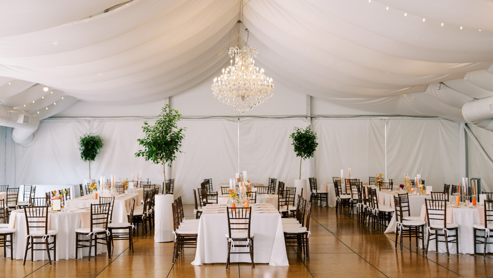Wedding tent with wooden tables