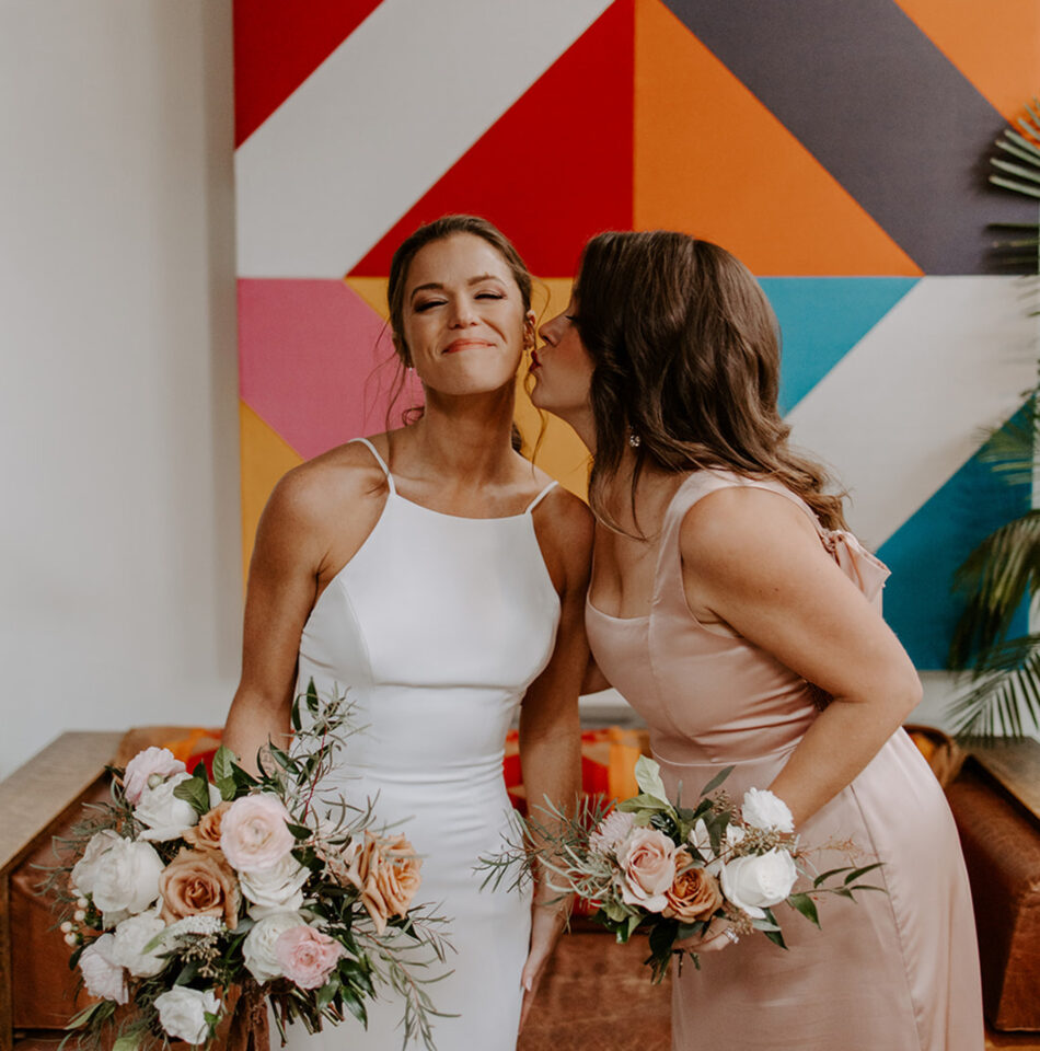 Happy bride holding flowers with mom